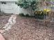 Backyard featuring stone walkway, lush greenery, and a privacy fence at 826 Glades Ne Ct, St Petersburg, FL 33702