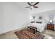 Bright bedroom features a ceiling fan, neutral paint, and an area rug over marble tile at 826 Glades Ne Ct, St Petersburg, FL 33702