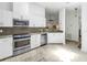 Updated kitchen with stainless steel appliances, granite countertops, and white cabinetry at 826 Glades Ne Ct, St Petersburg, FL 33702