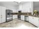Modern kitchen with white cabinets, stainless steel appliances, and granite countertops at 826 Glades Ne Ct, St Petersburg, FL 33702