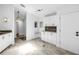 Bright kitchen area with white cabinets, granite countertops, and access to other rooms at 826 Glades Ne Ct, St Petersburg, FL 33702