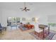 Bright living room featuring high ceilings, tile floors, and large sliding doors to the lanai at 826 Glades Ne Ct, St Petersburg, FL 33702