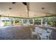 View of an open-air pavilion, with a tile floor and white table and chairs at 826 Glades Ne Ct, St Petersburg, FL 33702