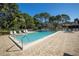 Community pool area with brick pavers and lounge chairs surrounded by lush landscaping at 826 Glades Ne Ct, St Petersburg, FL 33702