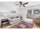 Bright sitting room with large window, marble tile flooring, and decorative area rug at 826 Glades Ne Ct, St Petersburg, FL 33702