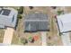 Aerial view showcases the neighborhood, highlighting the roof, surrounding streets, nearby homes, and landscaping at 832 Fox Hills Dr, Sun City Center, FL 33573