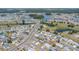 An aerial view of a neighborhood showcasing well-maintained homes, lush landscaping, water features, and mature trees at 832 Fox Hills Dr, Sun City Center, FL 33573