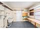 Basement area with lots of shelving, a utility sink, and a workbench at 832 Fox Hills Dr, Sun City Center, FL 33573