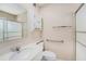 This is a bathroom with a sink, toilet, cabinet and updated shower at 832 Fox Hills Dr, Sun City Center, FL 33573
