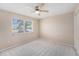 This is a bedroom with a window overlooking the neighborhood and neutral walls at 832 Fox Hills Dr, Sun City Center, FL 33573