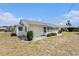 Cozy single-story white home with well-maintained landscaping and a screened porch, perfect for relaxed outdoor living at 832 Fox Hills Dr, Sun City Center, FL 33573