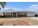 Charming single-story brick home featuring a well-maintained lawn and an attached garage at 832 Fox Hills Dr, Sun City Center, FL 33573