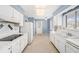Bright kitchen featuring white cabinets, appliances, a ceiling fan, and neutral walls at 832 Fox Hills Dr, Sun City Center, FL 33573