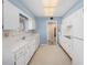 Classic kitchen featuring white cabinets, appliances, a window and neutral walls at 832 Fox Hills Dr, Sun City Center, FL 33573