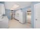 Bright kitchen featuring white cabinets, appliances, and a door to another room at 832 Fox Hills Dr, Sun City Center, FL 33573