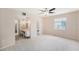 The main bedroom has a ceiling fan, and doors to the bathroom and vanity at 832 Fox Hills Dr, Sun City Center, FL 33573