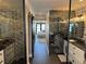 Bathroom hallway view to bedroom featuring geometric tile and a sliding barn door at 926 Eagle Ln, Apollo Beach, FL 33572