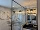 Modern bathroom featuring a glass shower and sleek white vanities with black countertops at 926 Eagle Ln, Apollo Beach, FL 33572