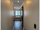 Hallway view of bathroom with modern tile, a glass shower, and black accents at 926 Eagle Ln, Apollo Beach, FL 33572