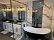 Luxury bathroom with a clawfoot tub, white cabinets, and black hardware at 926 Eagle Ln, Apollo Beach, FL 33572