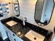 Stylish bathroom featuring a double vanity, black countertop, and modern fixtures at 926 Eagle Ln, Apollo Beach, FL 33572
