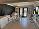 Dining room with a glass table, banquette seating, black accent wall, and view of the waterway at 926 Eagle Ln, Apollo Beach, FL 33572