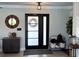 Elegant entryway featuring a modern door, wood accents, and stylish decor at 926 Eagle Ln, Apollo Beach, FL 33572