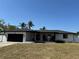 Inviting single-story house with a black garage door and a cozy front porch at 926 Eagle Ln, Apollo Beach, FL 33572