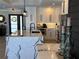 Bright kitchen with white cabinets, marble countertops, and stainless steel appliances, blending modern design elements at 926 Eagle Ln, Apollo Beach, FL 33572