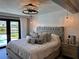 Luxurious main bedroom boasts waterfront views, a plush bed, and stylish decor, creating a serene retreat at 926 Eagle Ln, Apollo Beach, FL 33572