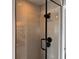 Elegant glass-enclosed shower with chic herringbone tile and modern fixtures at 926 Eagle Ln, Apollo Beach, FL 33572