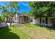 Backyard featuring a lush lawn, a shed, and a charming home with a screened porch at 101 22Nd N Ave, St Petersburg, FL 33704