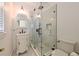 Bathroom with sleek glass enclosed shower, marble tile, and a vintage sink and cabinet at 101 22Nd N Ave, St Petersburg, FL 33704