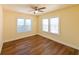 Bedroom with hardwood flooring, soft yellow walls, and bright natural light from two windows at 101 22Nd N Ave, St Petersburg, FL 33704