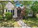 Charming home featuring a brick chimney, cozy front porch, and mature landscaping at 101 22Nd N Ave, St Petersburg, FL 33704