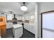 Bright kitchen with white cabinetry, brick backsplash, stainless steel appliances, and a kitchen island at 101 22Nd N Ave, St Petersburg, FL 33704