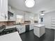 Modern kitchen features white cabinetry, brick backsplash, stainless steel appliances, and a kitchen island at 101 22Nd N Ave, St Petersburg, FL 33704