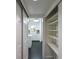 Hallway with a pantry and shelving storage space, with a view into the kitchen at 101 22Nd N Ave, St Petersburg, FL 33704