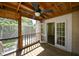 Covered porch shows outdoor living space with wood flooring, ceiling fan and exterior view at 101 22Nd N Ave, St Petersburg, FL 33704