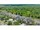 Aerial view of a neighborhood showcasing beautiful homes and lush greenery, surrounded by a serene forest at 10511 Mistflower Ln, Tampa, FL 33647