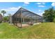 Well-maintained backyard with a screened-in pool, offering a perfect blend of relaxation and recreation at 10511 Mistflower Ln, Tampa, FL 33647