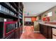 Home theater with a snack bar featuring a popcorn machine, mini fridge, and custom bar top at 10511 Mistflower Ln, Tampa, FL 33647