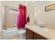 Bathroom featuring a tub-shower combo, a toilet, a vanity with a sink and a large mirror at 10511 Mistflower Ln, Tampa, FL 33647