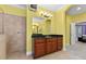 Bright bathroom with a wooden vanity cabinet, black granite countertop, walk-in shower and a large mirror at 10511 Mistflower Ln, Tampa, FL 33647