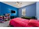 Bright bedroom with blue walls and two beds at 10511 Mistflower Ln, Tampa, FL 33647