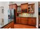 Kitchen features custom wood cabinets, granite countertops, stainless refrigerator and tile backsplash at 10511 Mistflower Ln, Tampa, FL 33647