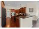 Well-appointed kitchen with dark wood cabinets, granite countertops, and a convenient center island with wine storage at 10511 Mistflower Ln, Tampa, FL 33647