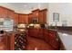 Gourmet kitchen features custom cabinets, granite countertops, stainless appliances, and an island wine rack at 10511 Mistflower Ln, Tampa, FL 33647