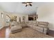 Spacious living room with hardwood floors, a ceiling fan, and a large sectional at 10511 Mistflower Ln, Tampa, FL 33647