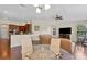 Open-concept living room features hardwood floors and seamlessly connects to the kitchen and dining area at 10511 Mistflower Ln, Tampa, FL 33647
